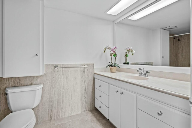 bathroom with vanity, tile patterned flooring, and toilet