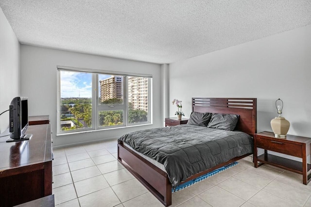 bedroom featuring light tile patterned flooring and a textured ceiling