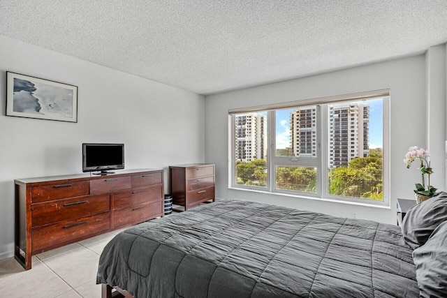 tiled bedroom with a textured ceiling