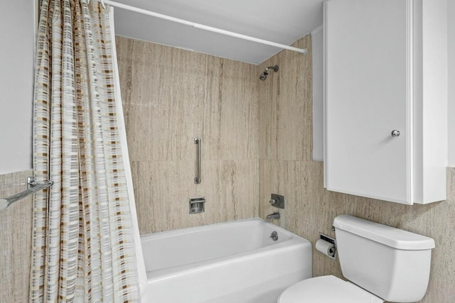 bathroom featuring shower / bath combination with curtain and toilet