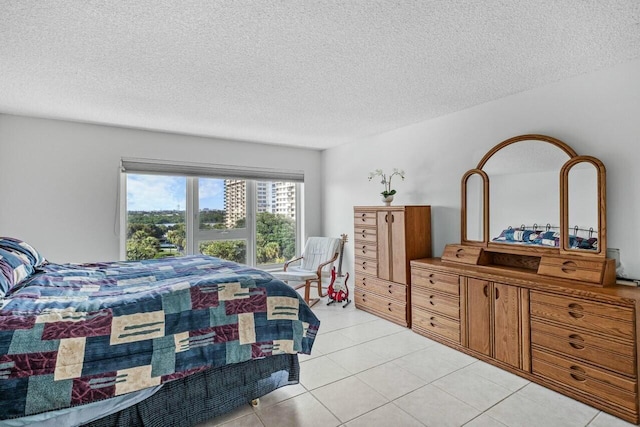 bedroom with light tile patterned floors and a textured ceiling