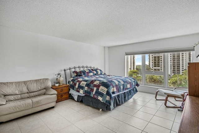 bedroom with light tile patterned floors and a textured ceiling