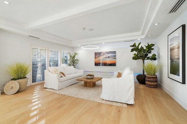 living room with beamed ceiling and wood-type flooring