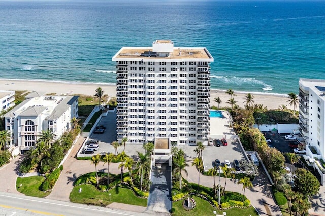 birds eye view of property with a view of the beach and a water view