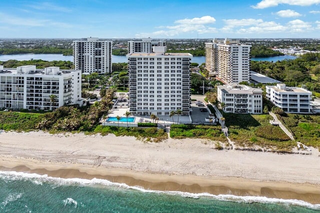 bird's eye view featuring a water view and a beach view