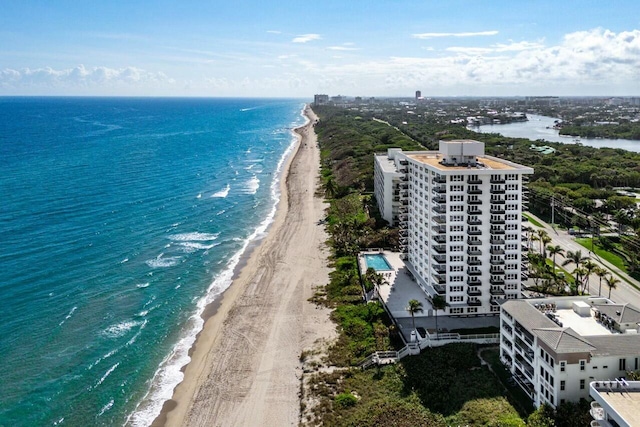 drone / aerial view featuring a water view and a view of the beach