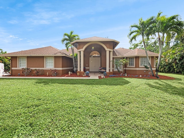 mediterranean / spanish-style house featuring a front yard