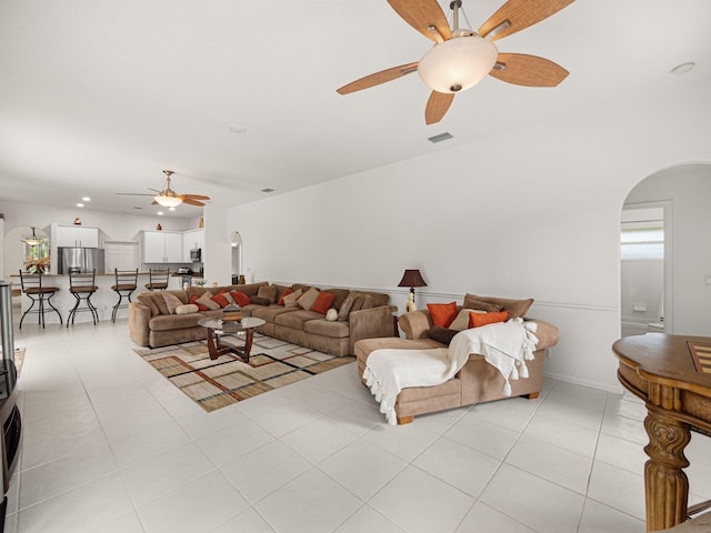 living room with ceiling fan and light tile patterned flooring