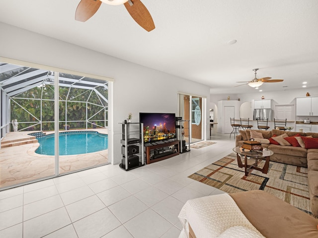 tiled living room with ceiling fan