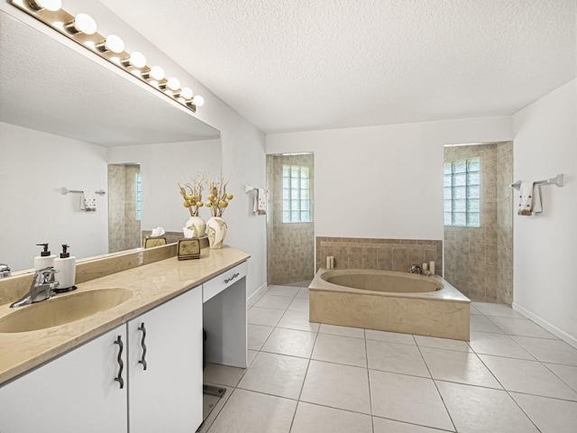 bathroom featuring a healthy amount of sunlight, vanity, a bath, and tile patterned flooring
