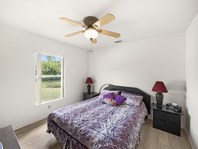 bedroom featuring light hardwood / wood-style flooring and ceiling fan