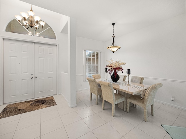 dining area with an inviting chandelier and light tile patterned flooring