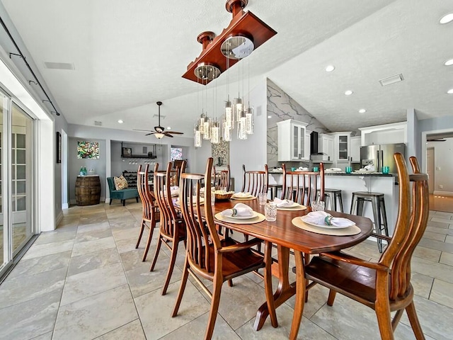 dining area featuring lofted ceiling and ceiling fan