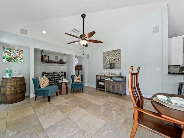 living area with lofted ceiling, a healthy amount of sunlight, and ceiling fan