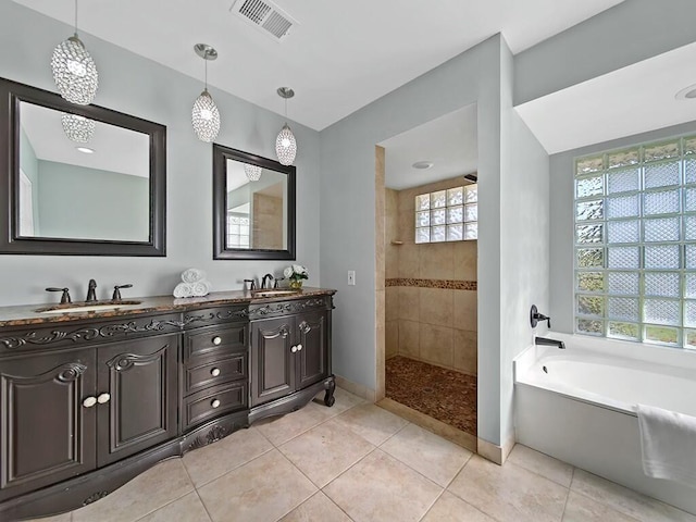 bathroom featuring tile patterned flooring, vanity, and plus walk in shower