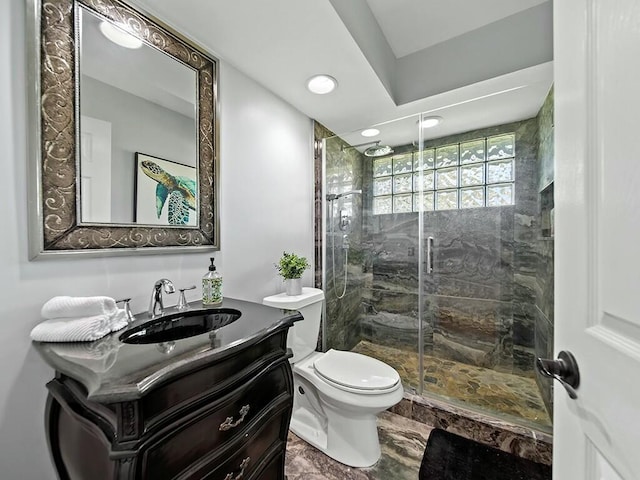 bathroom featuring vanity, toilet, and an enclosed shower