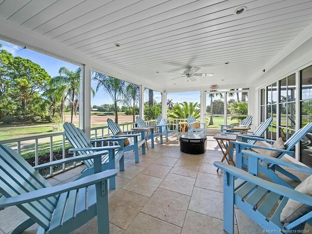 view of patio with ceiling fan and a fire pit