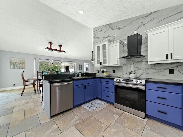 kitchen with sink, stainless steel appliances, white cabinets, blue cabinets, and wall chimney exhaust hood