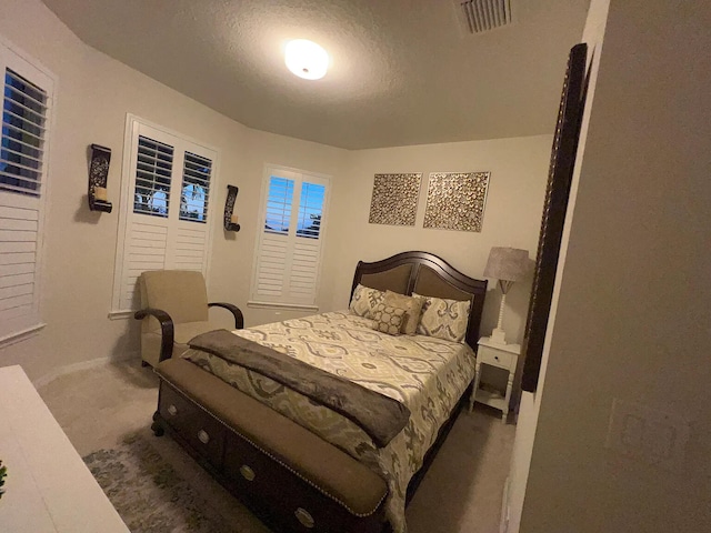 carpeted bedroom featuring a textured ceiling