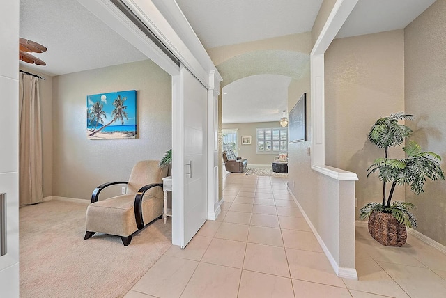 hallway featuring light tile patterned flooring