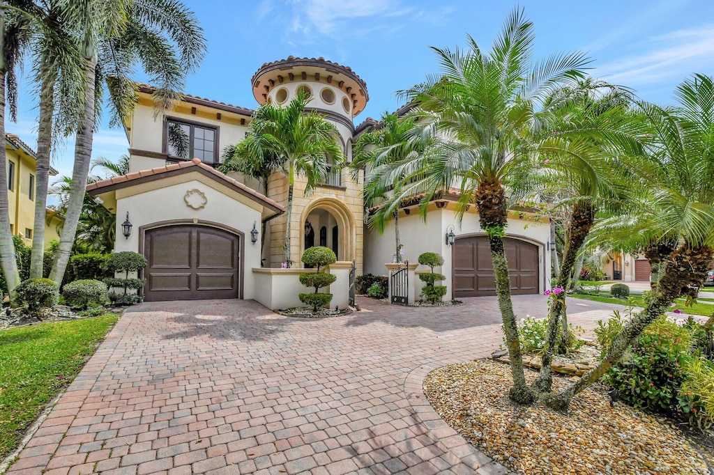 mediterranean / spanish home featuring a garage