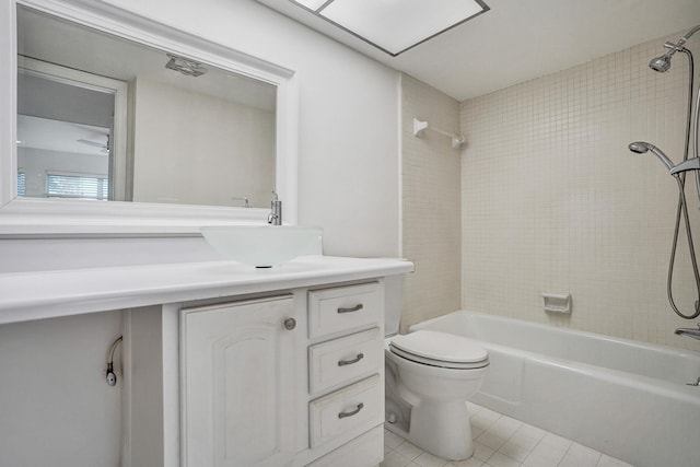 bathroom featuring tile patterned floors, toilet, vanity, and shower / washtub combination