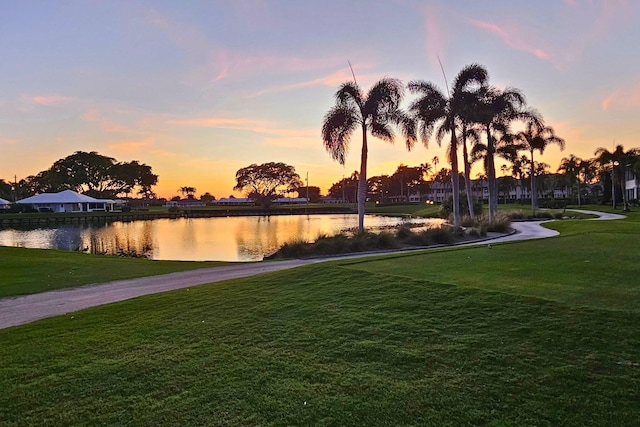 exterior space with a water view and a lawn