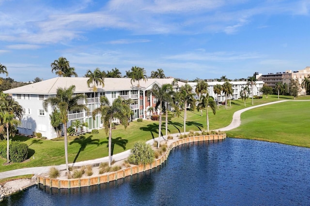surrounding community featuring a water view, a yard, and golf course view