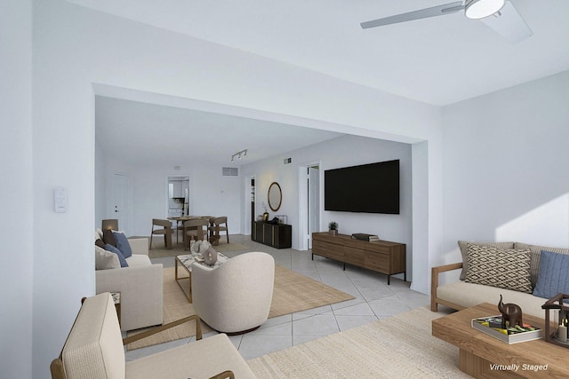 living area with light tile patterned flooring and ceiling fan