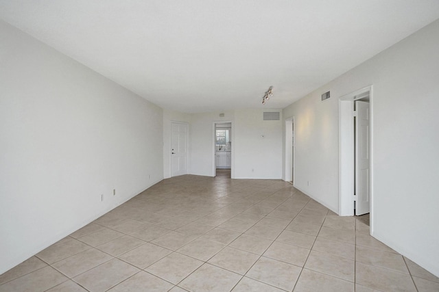 unfurnished room featuring light tile patterned floors