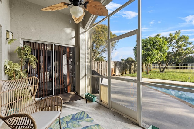 sunroom featuring ceiling fan