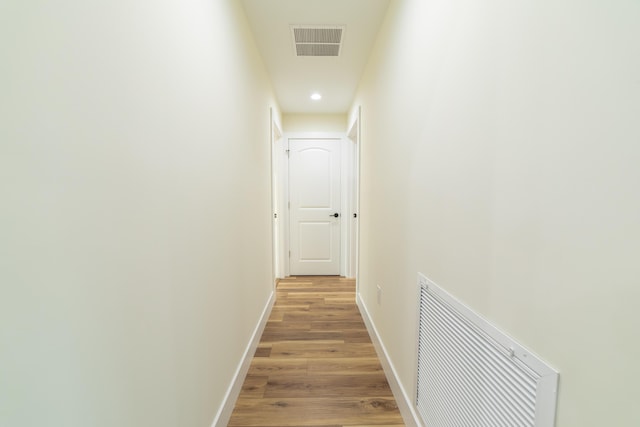 corridor with light hardwood / wood-style floors