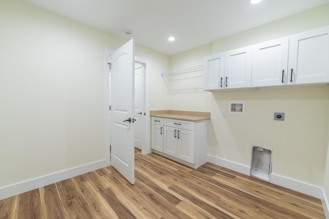 washroom with electric dryer hookup, hookup for a washing machine, cabinets, and light wood-type flooring