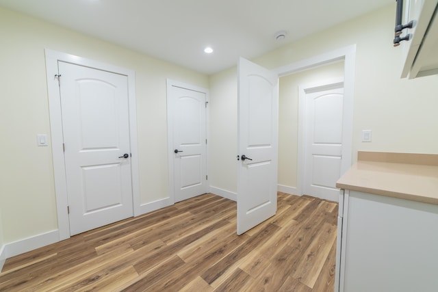 corridor with wood-type flooring