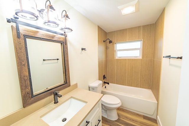 full bathroom with tiled shower / bath, vanity, toilet, and wood-type flooring