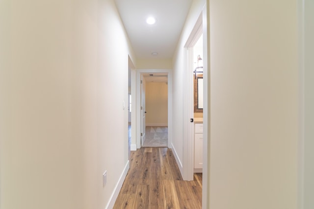 hallway with hardwood / wood-style floors