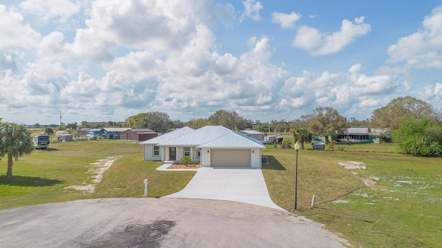 ranch-style home with a garage and a front lawn