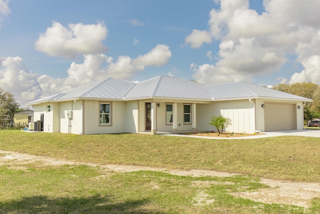 view of front of home with a garage and a front lawn