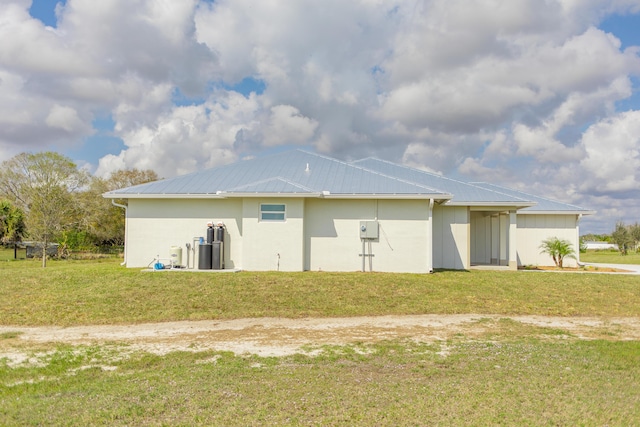 rear view of property with a yard