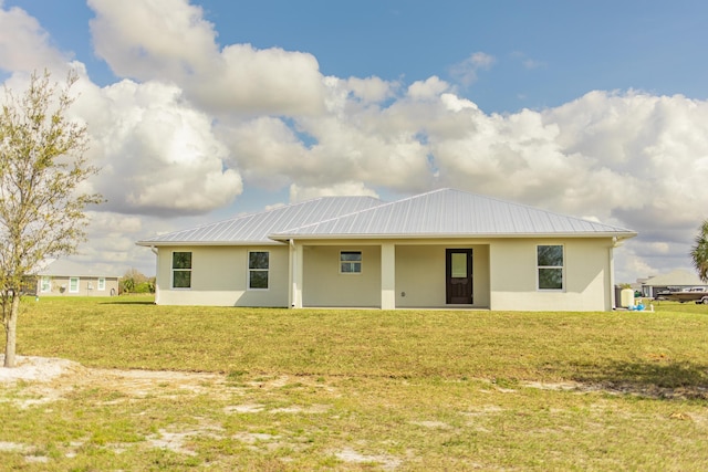 rear view of house with a yard