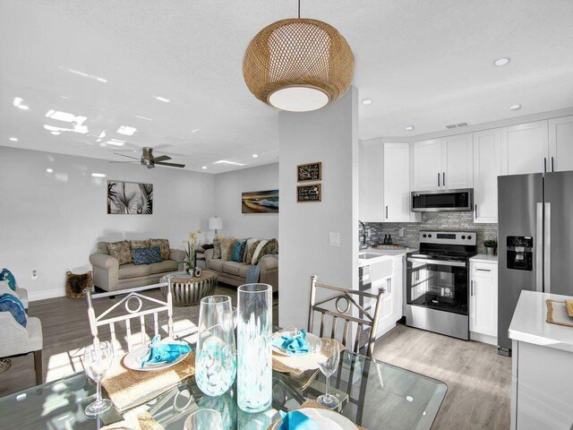 dining area featuring ceiling fan and light hardwood / wood-style flooring