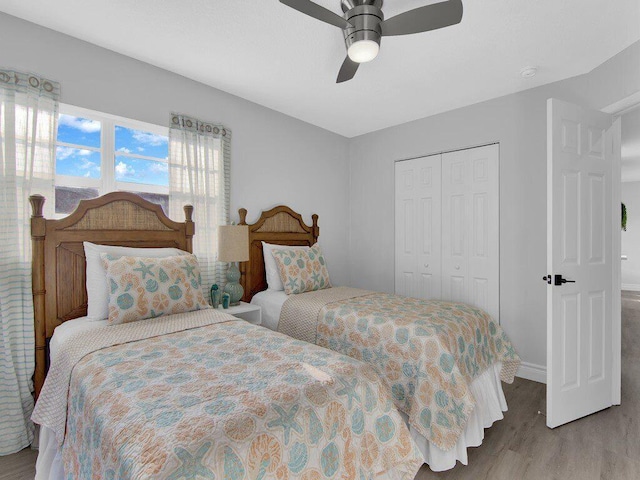 bedroom featuring ceiling fan, a closet, and light hardwood / wood-style flooring