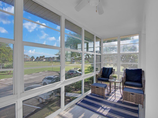 sunroom / solarium featuring ceiling fan