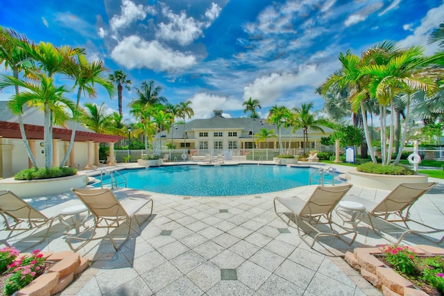 pool with fence and a patio