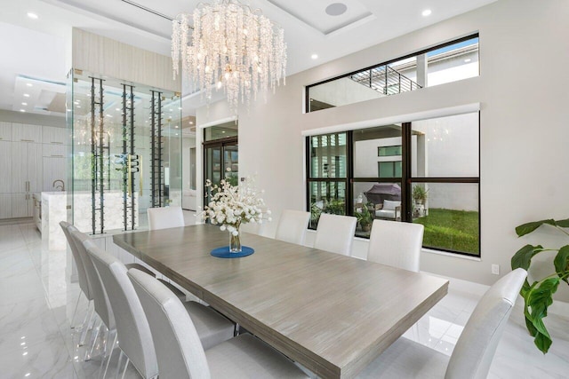 dining space with a chandelier, a high ceiling, and a wealth of natural light