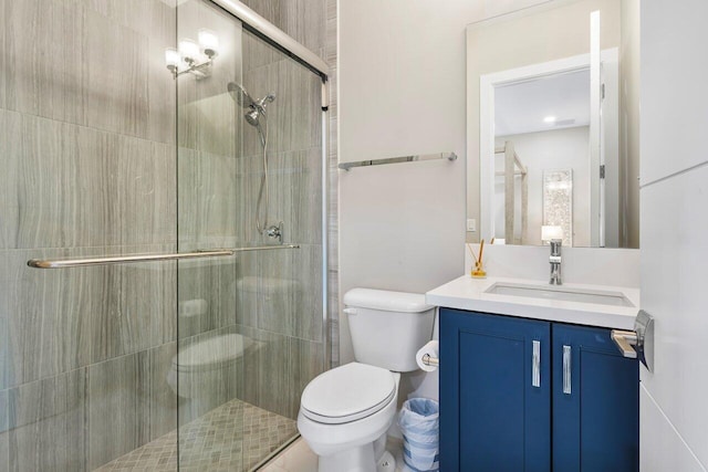 bathroom with vanity, toilet, and an enclosed shower