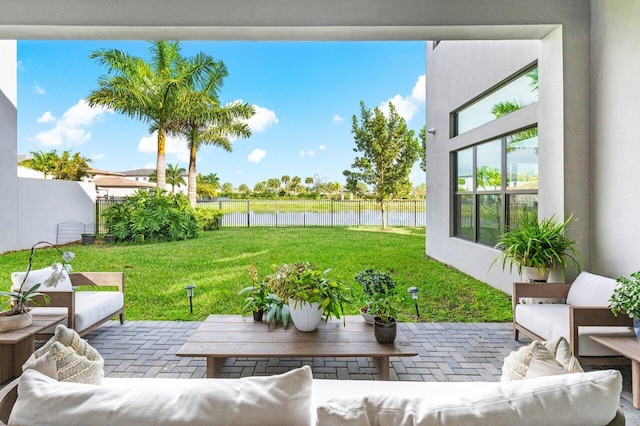 view of patio featuring an outdoor living space and a water view