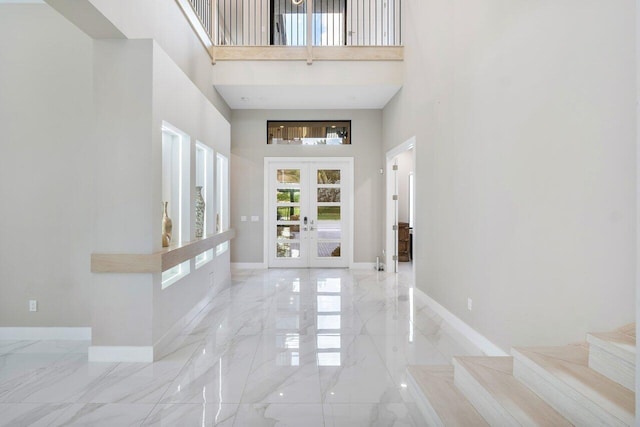 entrance foyer with french doors and a high ceiling