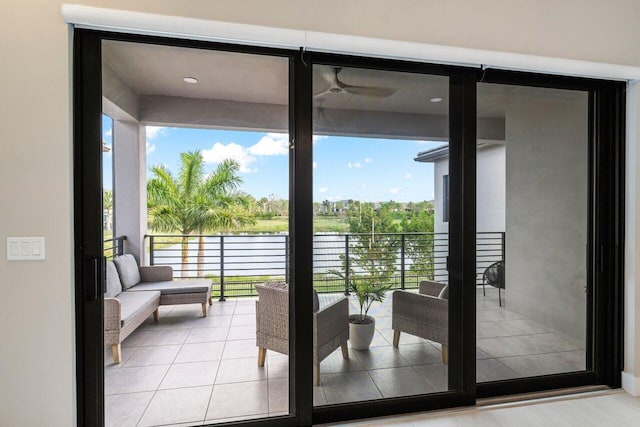 entryway featuring a water view and light tile patterned floors