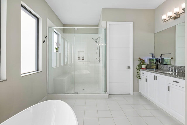 bathroom with tile patterned floors, vanity, and separate shower and tub